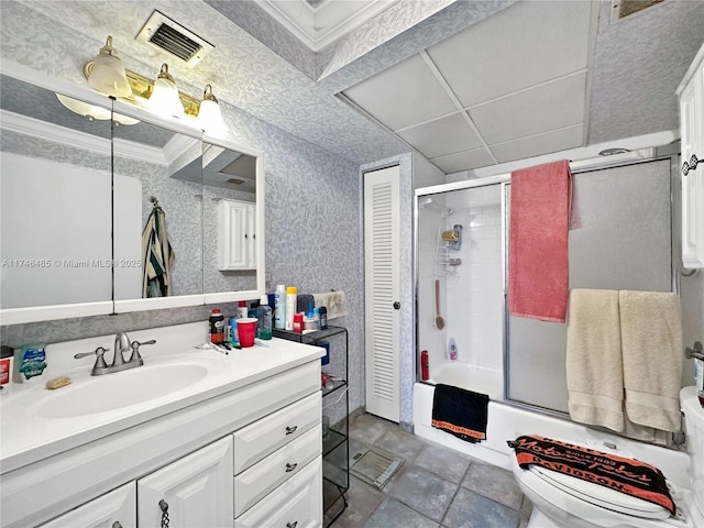 bathroom with visible vents, toilet, shower / bath combination with glass door, ornamental molding, and vanity