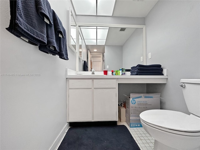 bathroom with toilet, baseboards, and vanity