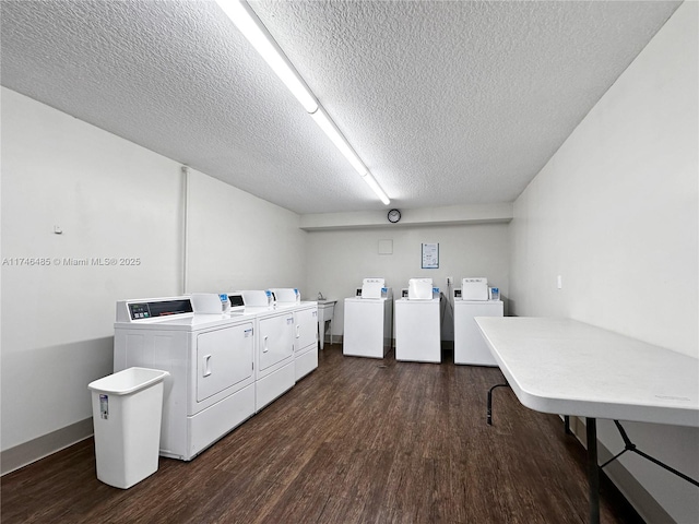 common laundry area featuring washing machine and dryer, dark wood-style flooring, and a textured ceiling