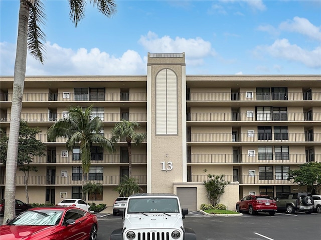 view of property featuring uncovered parking