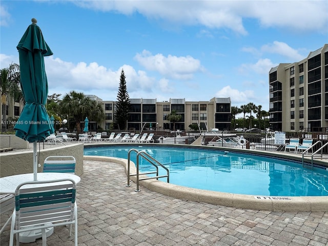 pool featuring a patio and fence