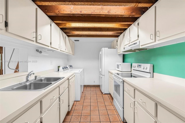 kitchen with beamed ceiling, white cabinetry, separate washer and dryer, sink, and white appliances