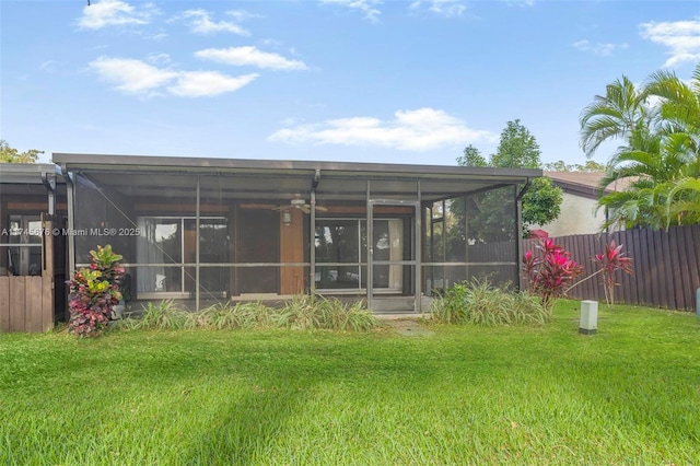 rear view of house featuring a lawn