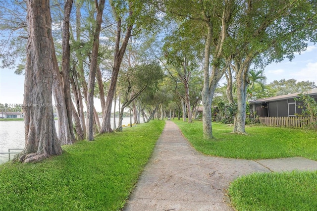 surrounding community featuring a yard and a water view