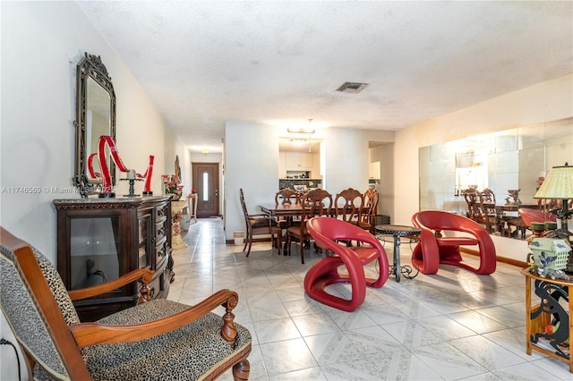 dining space with light tile patterned floors and a textured ceiling