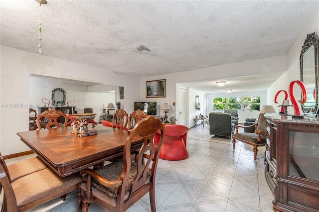 dining space with a textured ceiling