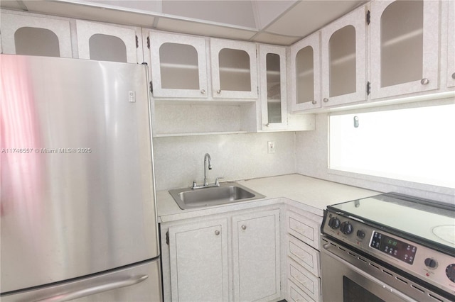 kitchen featuring sink, white cabinets, and appliances with stainless steel finishes