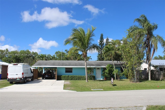 view of front of house featuring a front yard and a carport