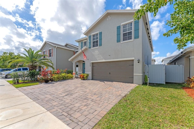 view of front of house with a garage and a front lawn