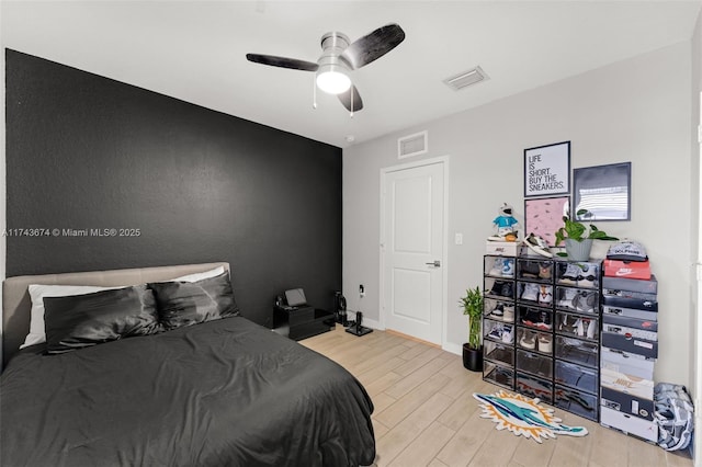 bedroom with ceiling fan and light hardwood / wood-style floors