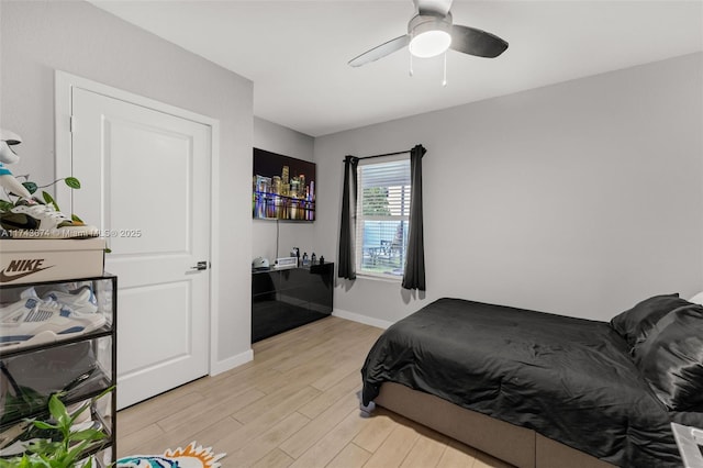 bedroom with light hardwood / wood-style floors and ceiling fan