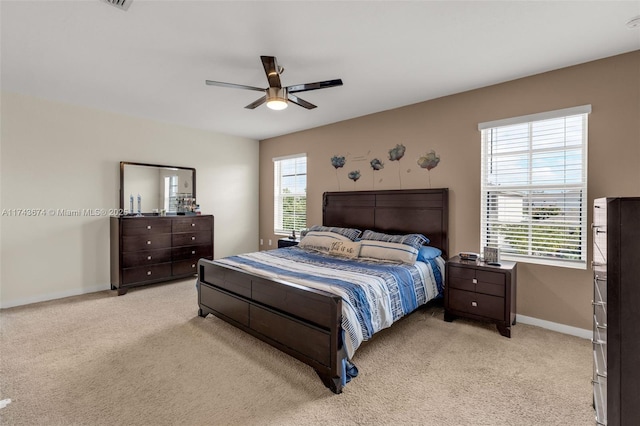 bedroom featuring light colored carpet and ceiling fan