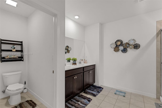 bathroom featuring tile patterned floors, toilet, and vanity