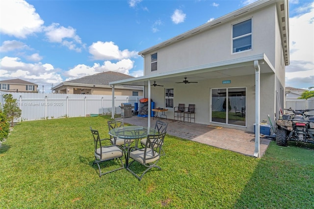 back of house featuring ceiling fan, a yard, and a patio area