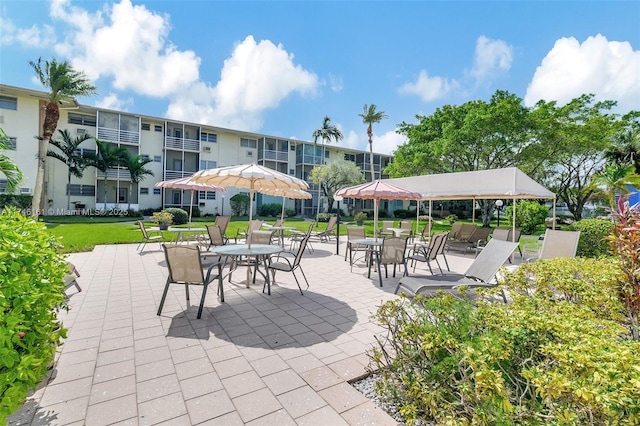 view of community featuring a patio area and a lawn