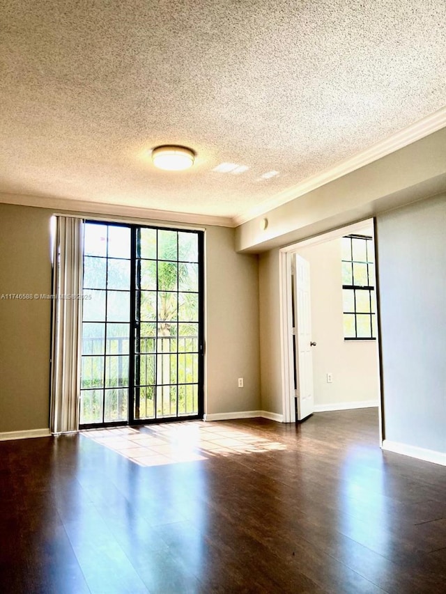 spare room featuring crown molding, a textured ceiling, and hardwood / wood-style flooring