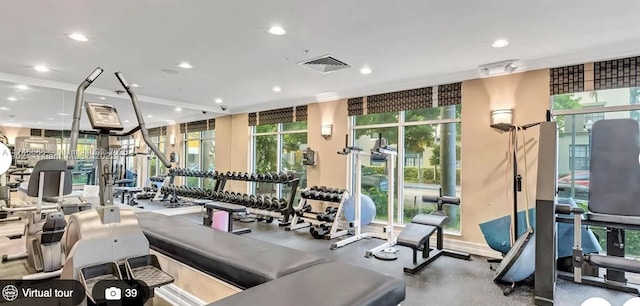 gym with floor to ceiling windows and plenty of natural light