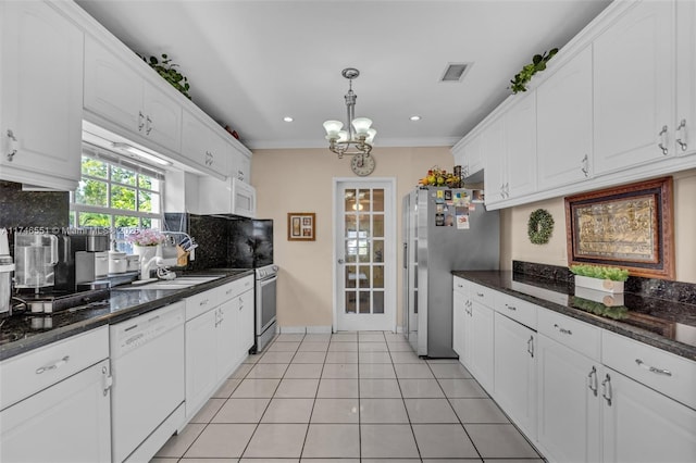 kitchen featuring stainless steel appliances, white cabinetry, and hanging light fixtures