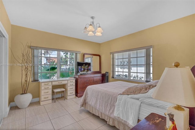 bedroom featuring an inviting chandelier and light tile patterned floors