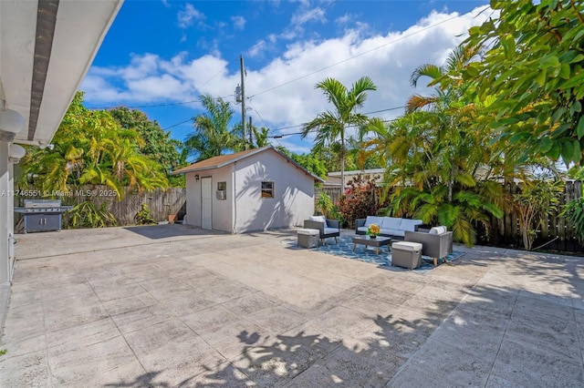 view of patio featuring a shed, an outdoor living space, and area for grilling