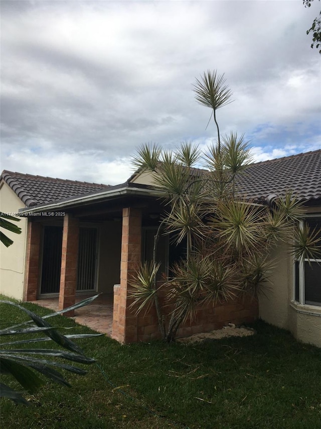 rear view of house with a yard