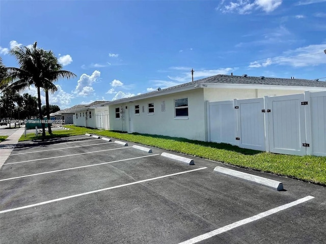 view of car parking with a lawn