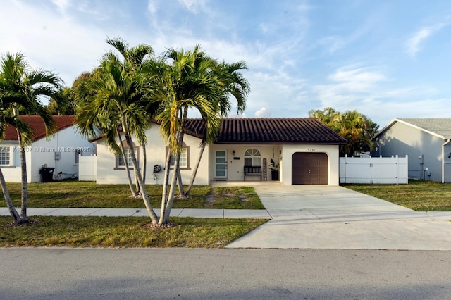 mediterranean / spanish home with a garage and a front yard