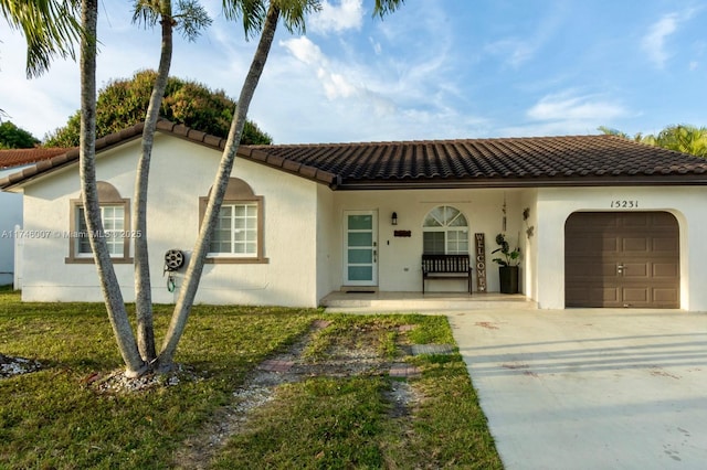 mediterranean / spanish house with a porch and a garage