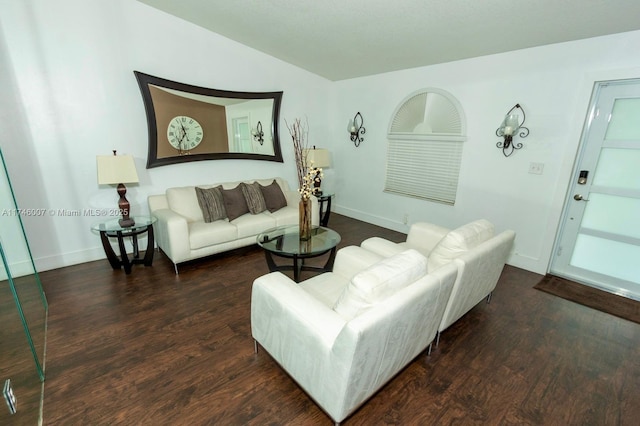 living room featuring vaulted ceiling and dark hardwood / wood-style floors