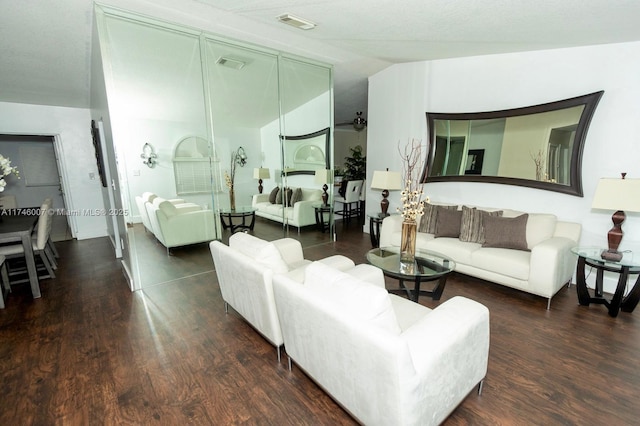 living room featuring vaulted ceiling and dark hardwood / wood-style floors