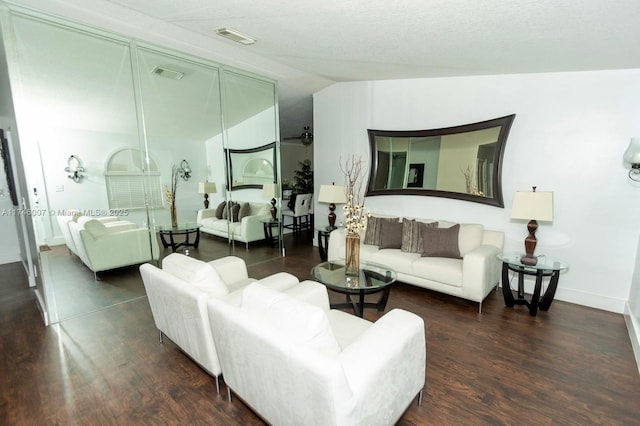 living room with vaulted ceiling and dark hardwood / wood-style floors