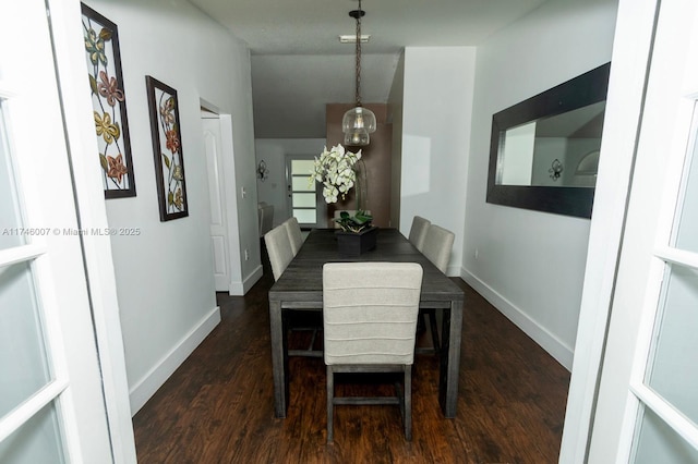 dining space with dark hardwood / wood-style flooring