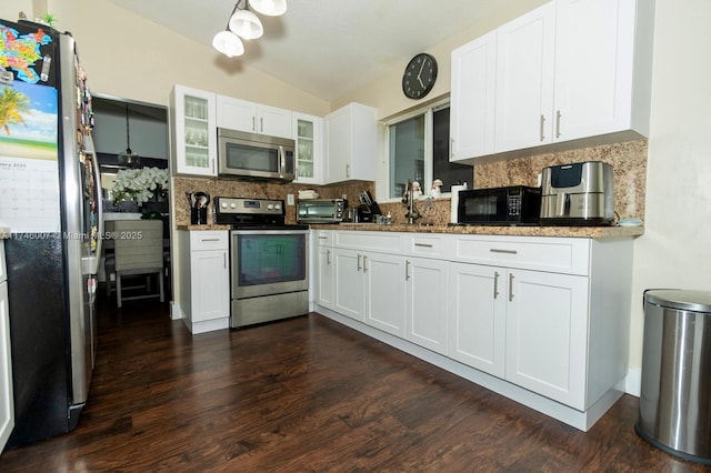 kitchen featuring white cabinetry, decorative backsplash, and stainless steel appliances