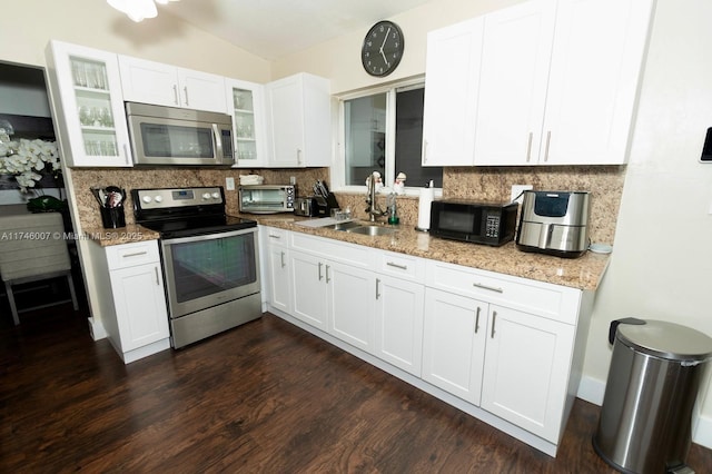 kitchen featuring sink, backsplash, stainless steel appliances, and white cabinets