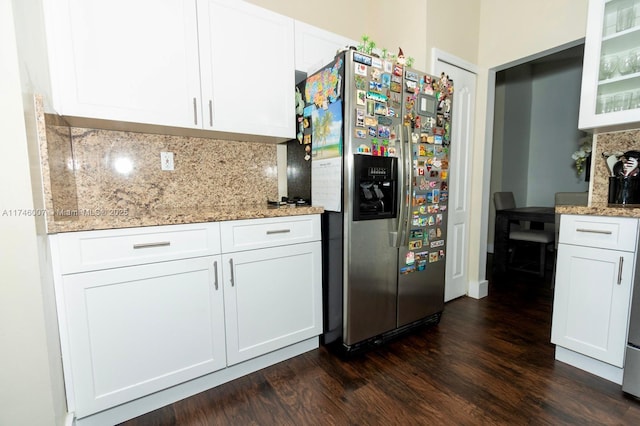 kitchen featuring white cabinetry, stainless steel fridge, light stone counters, and backsplash