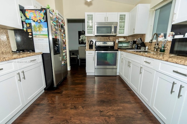 kitchen featuring light stone countertops, white cabinetry, appliances with stainless steel finishes, and sink