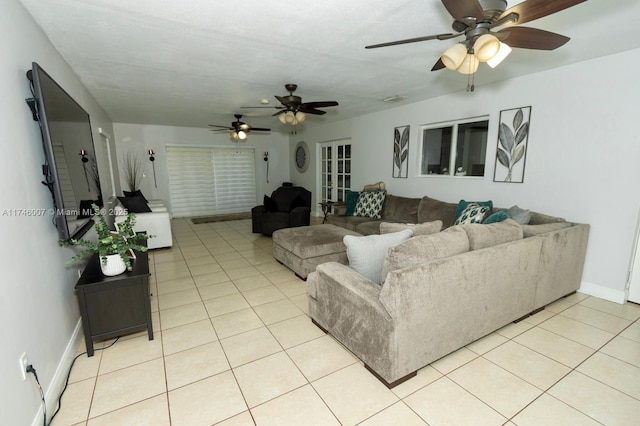 living room featuring light tile patterned floors and ceiling fan