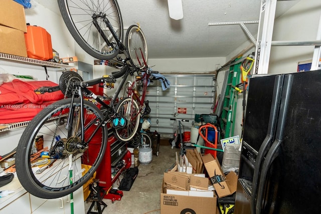 garage featuring black fridge with ice dispenser