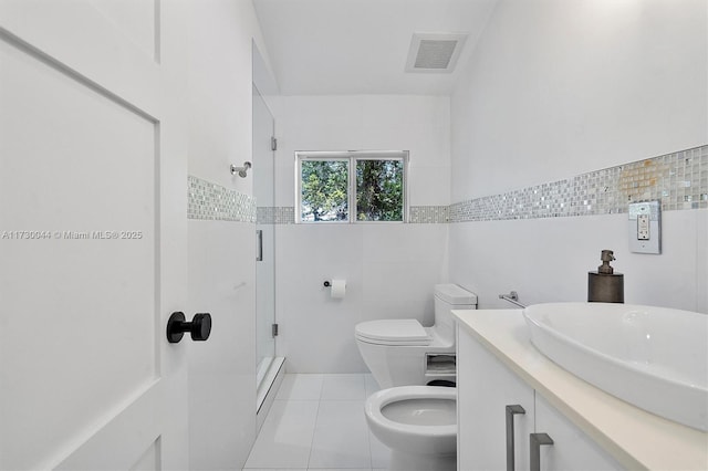 bathroom with tile walls, visible vents, toilet, a stall shower, and tile patterned floors