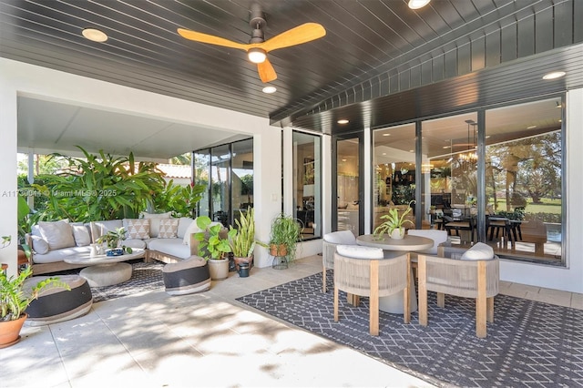 view of patio featuring ceiling fan, an outdoor living space, and outdoor dining space