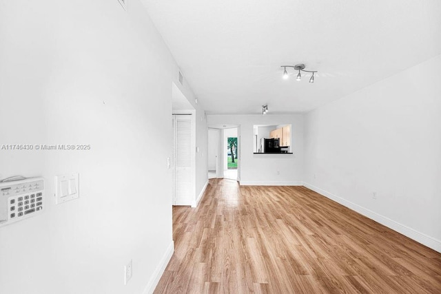 3505 Briar Bay Blvd Unit 104, West Palm Beach, FL 33411 - unfurnished living room with light wood-style floors and baseboards