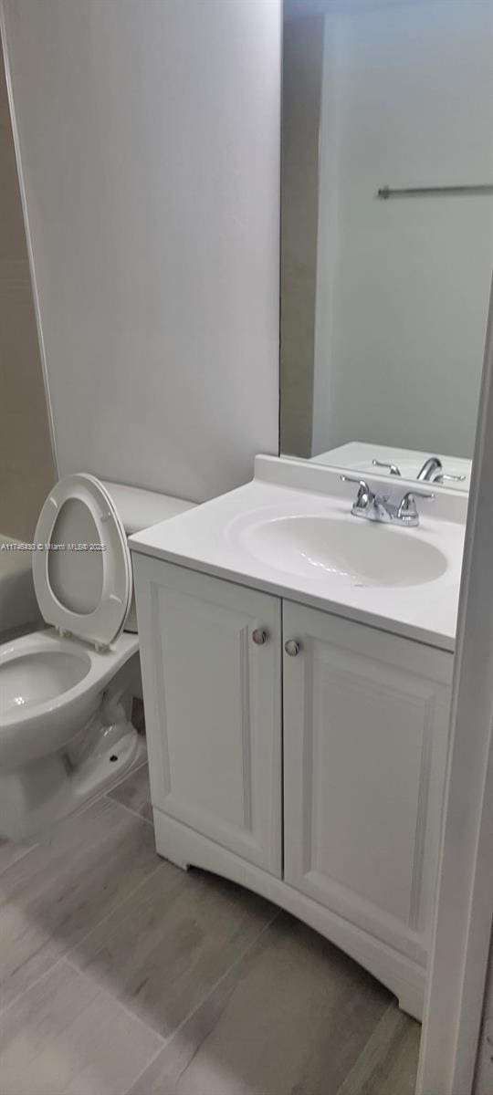 3505 Briar Bay Blvd Unit 104, West Palm Beach, FL 33411 - bathroom featuring vanity and toilet
