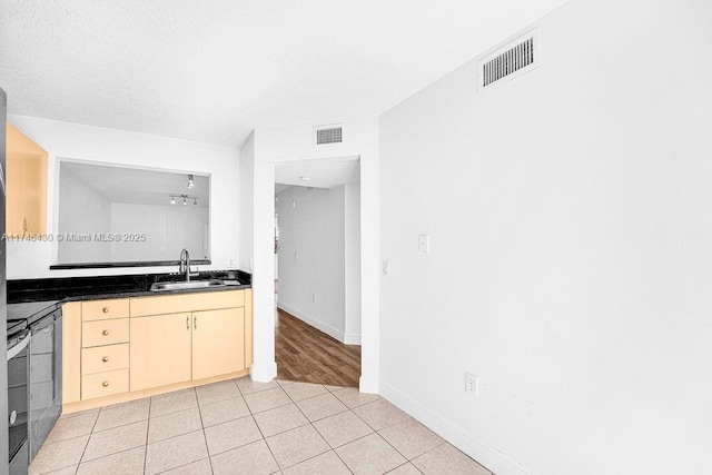 3505 Briar Bay Blvd Unit 104, West Palm Beach, FL 33411 - kitchen with a sink, dark countertops, light tile patterned floors, stainless steel range, and baseboards