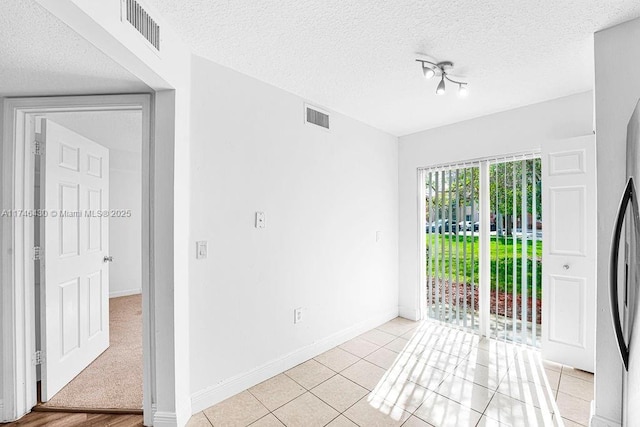 3505 Briar Bay Blvd Unit 104, West Palm Beach, FL 33411 - empty room featuring a textured ceiling, baseboards, and light tile patterned floors