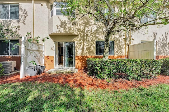 3505 Briar Bay Blvd Unit 104, West Palm Beach, FL 33411 - back of property featuring stucco siding and central AC