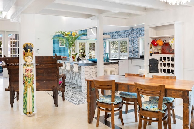 dining room featuring french doors and beam ceiling