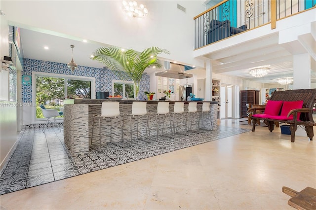 welcome area with visible vents and a notable chandelier