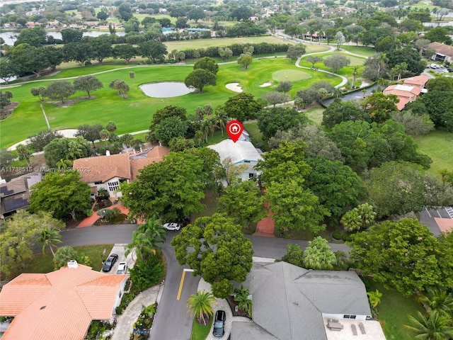 birds eye view of property with view of golf course and a residential view