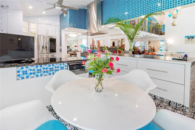 dining area with a ceiling fan and wine cooler