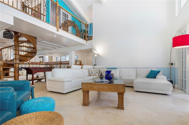 living room with beam ceiling and high vaulted ceiling
